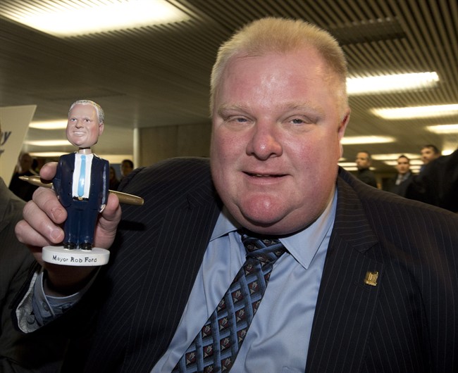 Toronto Mayor Rob Ford holds a Rob Ford bobblehead doll at Toronto city hall on Tuesday, Nov. 12, 2013. Hundreds of people lined up to be the first to own a Mayor Rob Ford bobblehead.