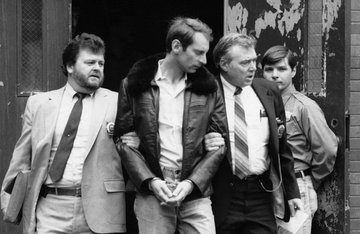 In this Wednesday, Jan. 16, 1985 file photo, Bernhard Goetz, second from left, is escorted by police as he is taken out of criminal court in New York. Police say Goetz, 65, was nabbed in a sting operation in Union Square on Friday afternoon, Nov. 1, 2013 selling $30 worth of marijuana to an undercover officer.