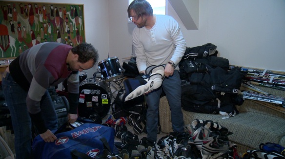 Andrew Wahba (left) and James Turner (right) prepare to send hockey equipment to India.