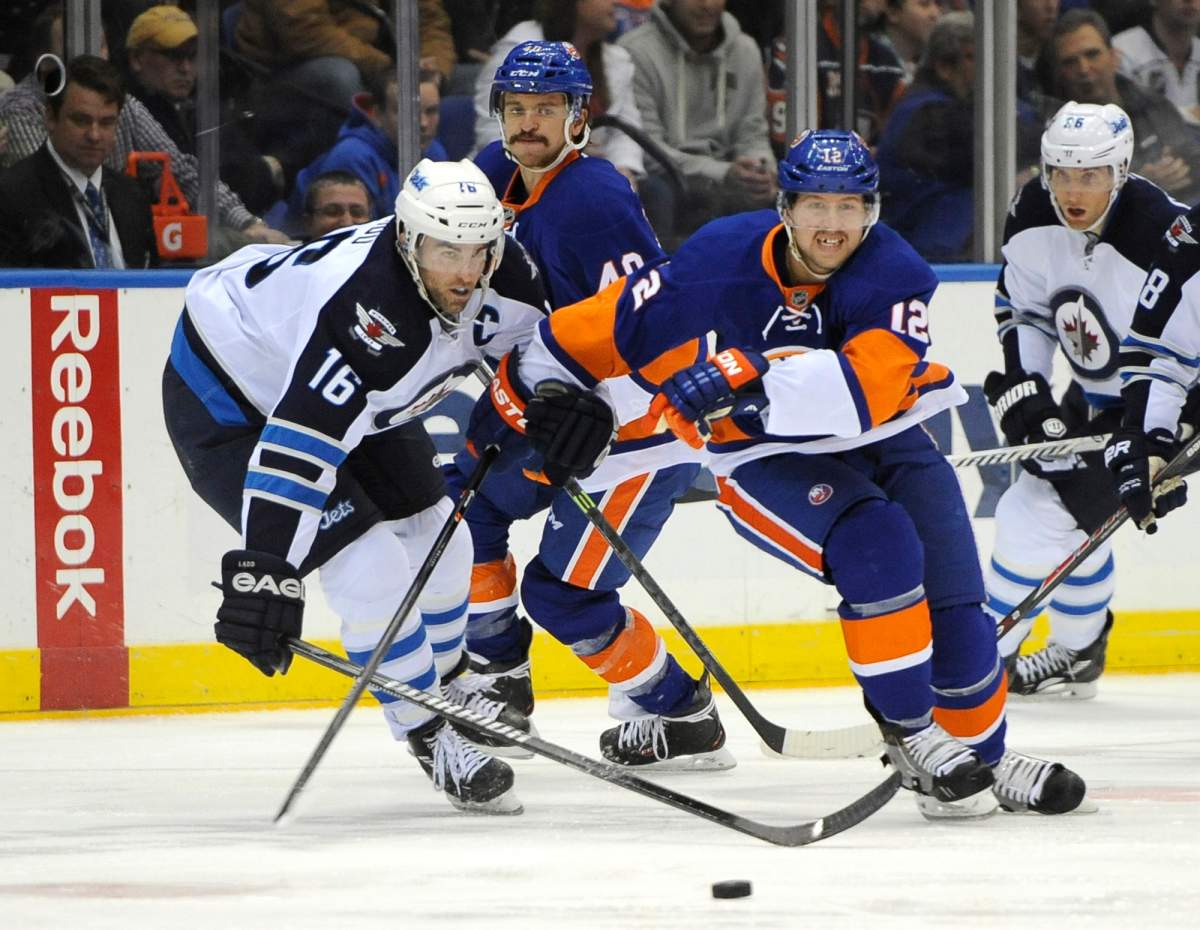 Winnipeg Jets left wing Andrew Ladd (16) cuts in on New York Islanders' Josh Bailey (12) in the second period of an NHL hockey game on Wednesday, Nov. 27, 2013, in Uniondale, N.Y. Ladd scored during the Jets 3-2 win.