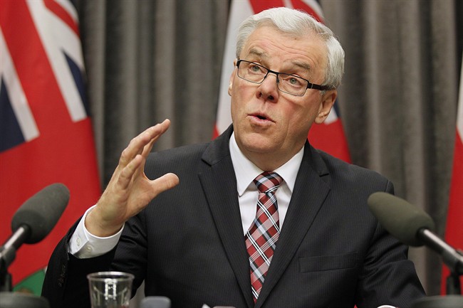 Manitoba Premier Greg Selinger responds to media questions at the Manitoba Legislature in Winnipeg, Tuesday, Nov. 12, 2013.