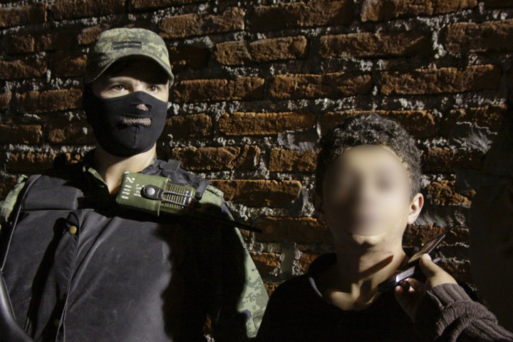 A Mexican soldier escorts Edgar Jimenez Lugo aka 'El Ponchis', alleged member of the South Pacific drug cartel, in Cuernavaca, Morelos State, Mexico, on December 2, 2010.