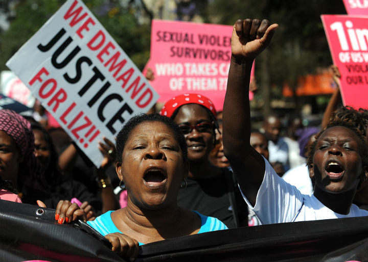 Kenyan protestors march towards the police headquarters on October 31, 2013 in Nairobi to deliver a petition of over a million names demanding justice after men accused of brutally gang raping a schoolgirl cut grass as punishment. 