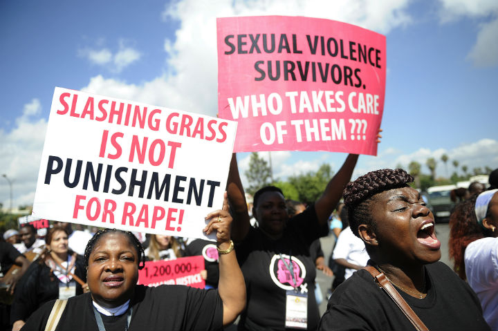 Kenyan protestors march towards the police headquarters on October 31, 2013 in Nairobi to deliver a petition of over a million names demanding justice after men accused of brutally gang raping a schoolgirl cut grass as punishment.