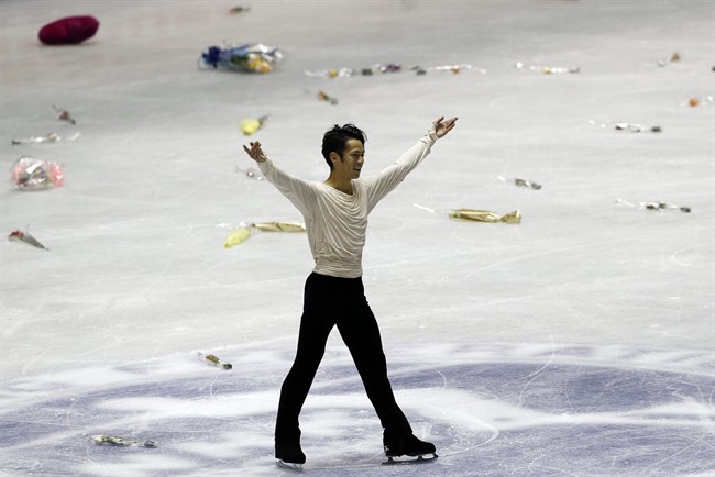 Daisuke Takahashi of Japan waves after his performance during the free skating of the NHK Trophy Figure Skating in Tokyo, Saturday, Nov. 9, 2013. (AP Photo/Koji Sasahara).