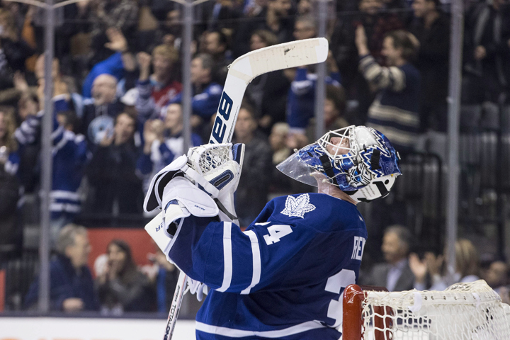 Toronto Maple Leafs goaltender James Reimer celebrates after saving a shot from Washington Capitals' Troy Brouwer (not shown) to win during shootout NHL hockey action in Toronto on Saturday November 23, 2013. 