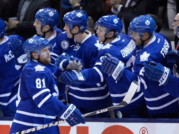 Toronto Maple Leafs' Phil Kessel is congratulated by teammates after scoring against the New Jersey Devils during third period NHL action in Toronto on Nov. 8, 2013. THE CANADIAN PRESS/Frank Gunn.