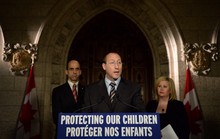 Peter MacKay, Minister of Justice and Attorney General of Canada speaks as Steven Blaney, Minister of Public Safety and Emergency Preparedness, back right, Lianna McDonald, Executive Director of the Canadian Centre for Child Protection, join him in making an announcement on Parliament Hill in Ottawa on Wednesday, Nov. 20, 2013., as part of Bullying Awareness Week. THE CANADIAN PRESS/Sean Kilpatrick.