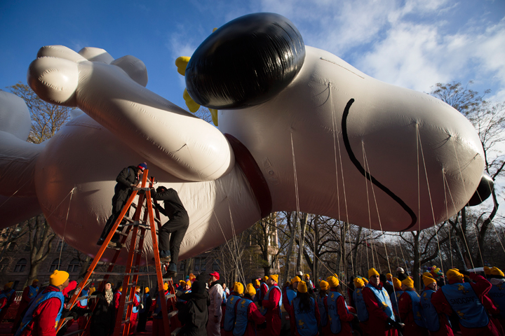 Workers prepare the giant Snoopy balloon before the 87th Annual Macy’s Thanksgiving Day Parade, Thursday, Nov. 28, 2013, in New York. (Photo credit: AP Photo)