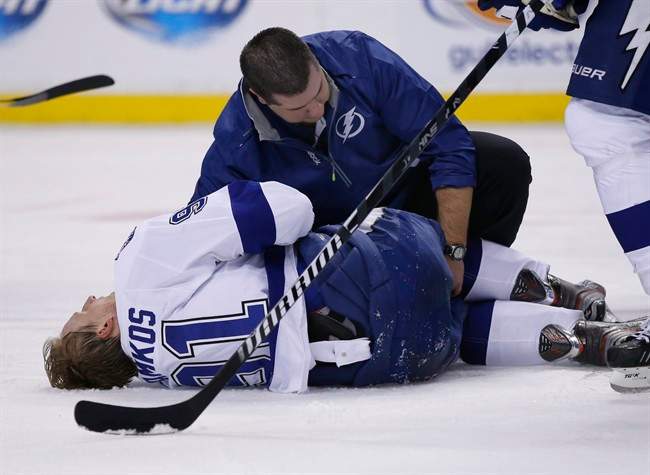 Tampa Bay Lightning center Steven Stamkos is attended to on the ice after banging into the goalpost during the second period of an NHL hockey game against the Boston Bruins in Boston Monday, Nov. 11, 2013. 