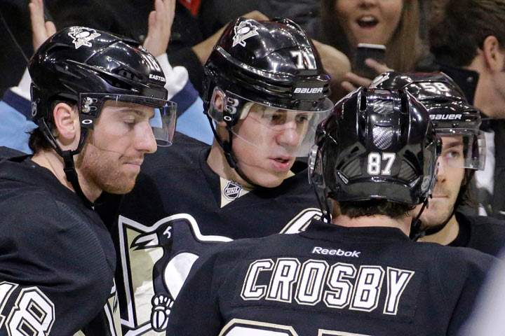 Pittsburgh Penguins' Evgeni Malkin (71) celebrates his second-period goal with teammates during an NHL hockey game against the Toronto Maple Leafs in Pittsburgh, Wednesday, Nov. 27, 2013. (AP Photo/Gene J. Puskar).