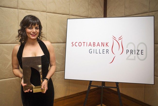2013 Giller Prize winner Lynn Coady for her book "Hellgoing" poses with the prize in Toronto.