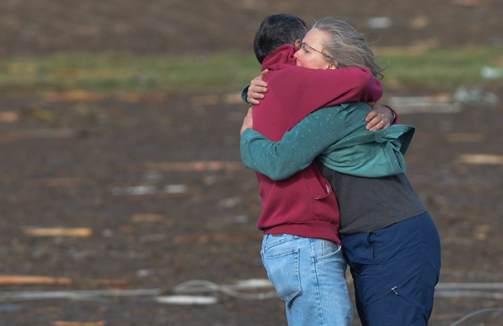 Residents embrace after they discovered their home was destroyed when a tornado and thunderstorms tore through a portion of Washington, Ill., on Sunday, Nov.17, 2013. (Photo credit: AP Photo)
