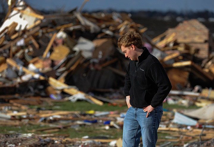 Paul Tubbs of Washington, Ill., looks over the remains of his home on Devon Lane in Washington after a tornado tore through the north part of Washington on Sunday, Nov. 17, 2013. (Photo credit: AP Photo)