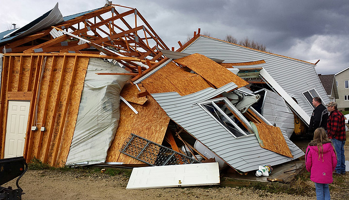 In a photo provided by Dodge County Emergency Management, A garage in the Town of Hustisford collapsed and walls were turned inside-out after severe weather moved through the area Sunday, Nov. 17, 2013.