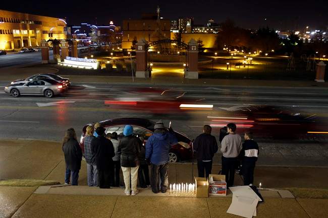 Cars pass by a small group of death penalty opponents outside St. Francis Xavier Church as they protest the scheduled execution of Missouri death row inmate Joseph Paul Franklin, Tuesday, Nov. 19, 2013, in St. Louis. 