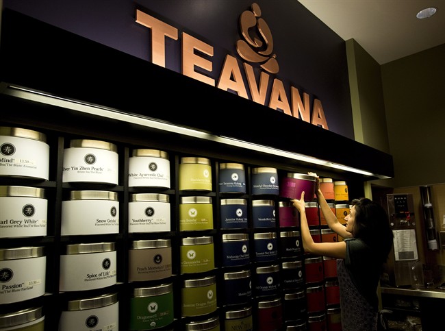 Teavana employee Dianne Pereira helps customers with different types of tea at the Teavana store in Toronto on Friday, Nov. 1, 2013. Canadian business owners are seeing a big growth in tea drinkers. THE CANADIAN PRESS/Nathan Denette.