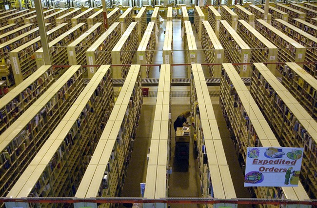 A worker scans bar codes in the book warehouse area at the Amazon.com shipping and receiving facility. 