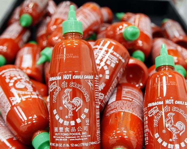 In this Tuesday, Oct 29, 2013, file photo, Sriracha chili sauce bottles are produced at the Huy Fong Foods factory in Irwindale, Calif. 