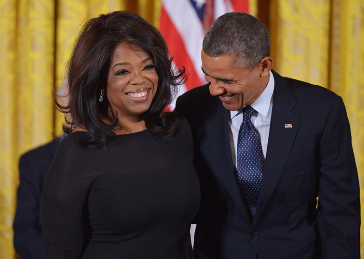 US President Barack Obama chats with broadcast journalist Oprah Winfrey before presenting her with the Presidential Medal of Freedom during a ceremony in the East Room of the White House on November 20, 2013 in Washington, DC.