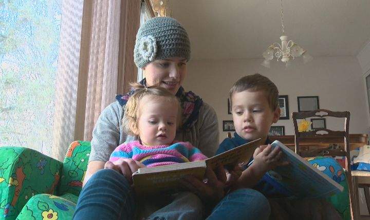 Jocelyn Ogrins reads to her children Friday, November 29, 2013.