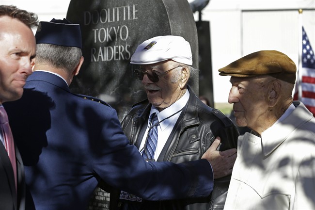 Two of the four surviving members of the 1942 raid on Tokyo led by Lt. Col. Jimmy Doolittle, Edward Saylor, center, and Richard Cole, right, are thanked by Gen. Mark Welsh III, Chief of Staff of the US Air Force, and Eric Fanning, left, acting Secretary of the US Air Force, Saturday, Nov. 9, 2013, at a monument marking the raid at the National Museum of the US Air Force in Dayton, Ohio. (AP Photo/Al Behrman).