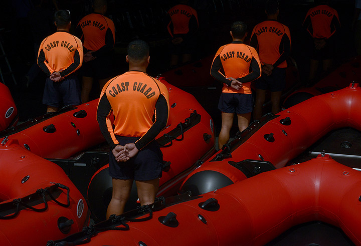 Philippine Coast Guard (PCG) personnel stand in formation beside newly-acquired rubber boats following a blessing ceremony in Manila on November 6, 2013.