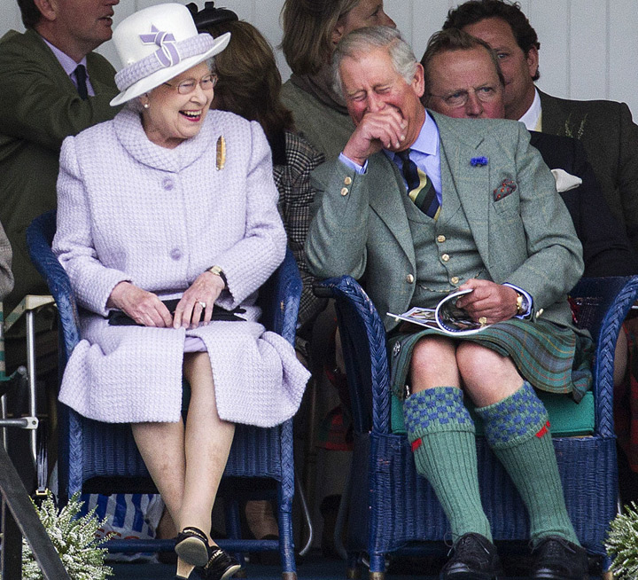 Queen Elizabeth II and Prince Charles share a laugh at the Braemar Gathering, Aberdeenshire, Scotland on September 1, 2012. (Photo credit: AP Photo)