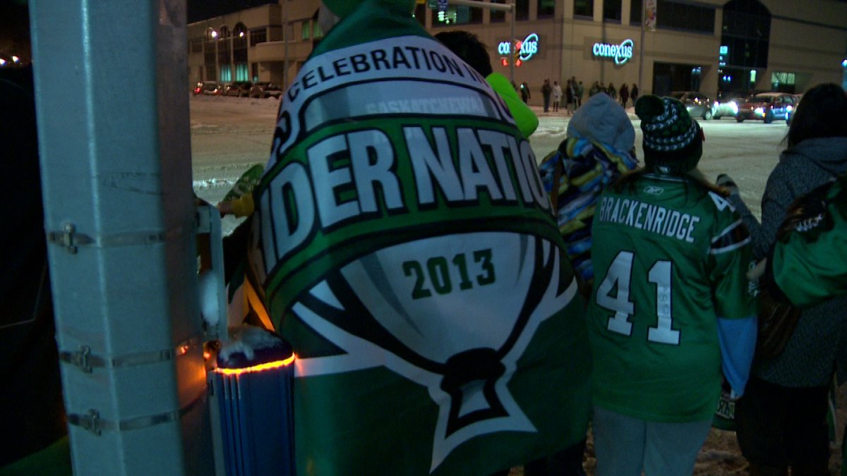 Saskatchewan Roughrider fans celebrate the team’s berth into the Grey Cup Finals on the Green Mile in Regina.  