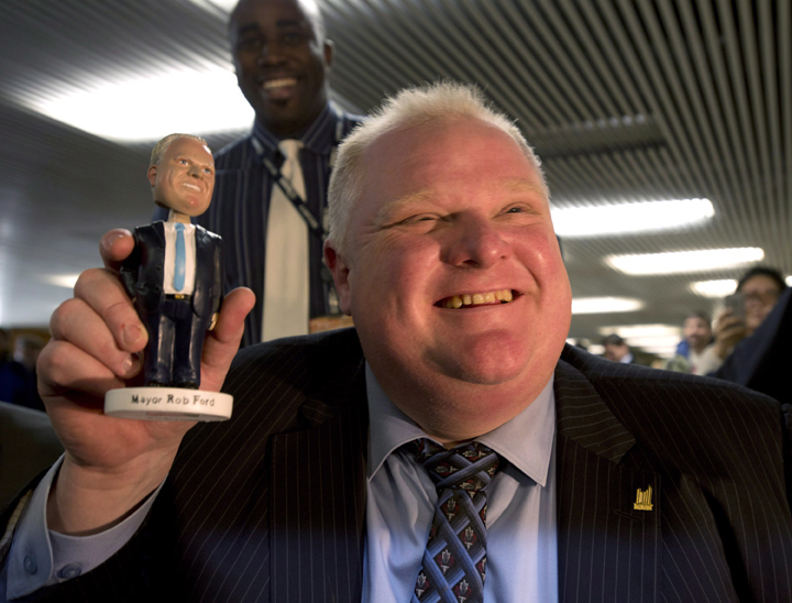 Toronto Mayor Rob Ford holds a Rob Ford bobblehead doll at Toronto city hall on Tuesday, Nov. 12, 2013.