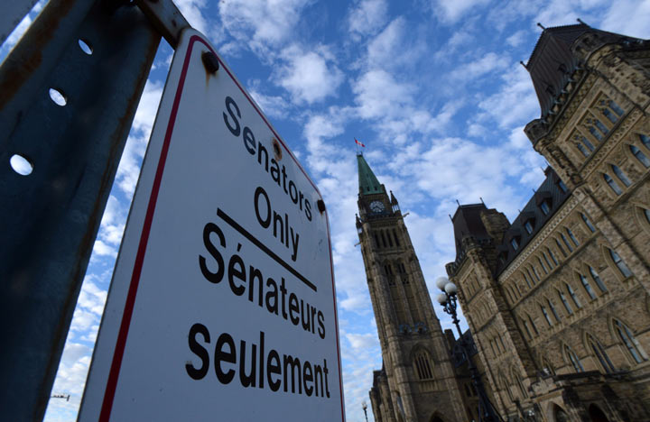 A "Senators Only" parking sign is displayed on Parliament Hill in Ottawa on Tuesday, November 5, 2013. 