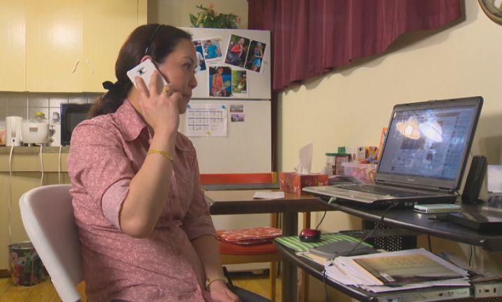 Erlinga Tan sits in her Edmonton home, waiting to hear from her family in the Philippines. 