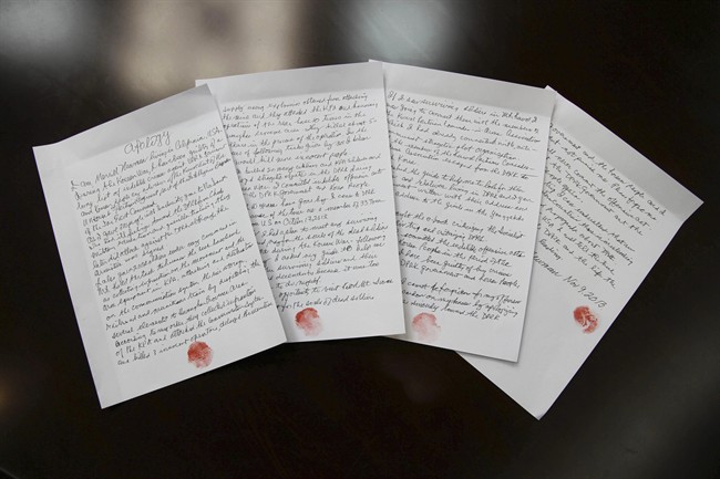 In this Nov. 9, 2013 photo released by the Korean Central News Agency (KCNA) and distributed Nov. 30, 2013 by the Korea News Service, hand written statements with red thumb prints, which North Korean authorities say is an apology written and read by 85-year-old U.S. citizen Merrill Newman, lie on a table in North Korea. 