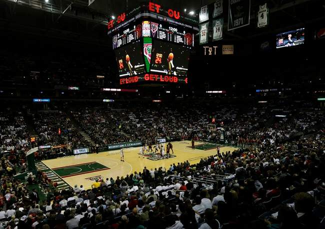 The Milwaukee Bucks and Toronto Raptors tip off during the first half of an NBA basketball game Saturday, Nov. 2, 2013, in Milwaukee. The game is being played on the Bucks old floor after their new floor was found to be too slippery to play on. (AP Photo/Morry Gash).