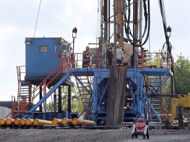In this June 25, 2012 file photo, a crew works on a gas drilling rig at a well site for shale based natural gas in Zelienople, Pa.