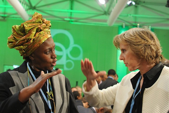 EU Commisioner for Climate Action Connie Hedegaard, right, talks with Alice Akinyi Kaudia from Kenya prior to the opening of the High-level Segment of the UN Climate Change Conference in Warsaw, Poland, Tuesday, Nov. 19, 2013. 