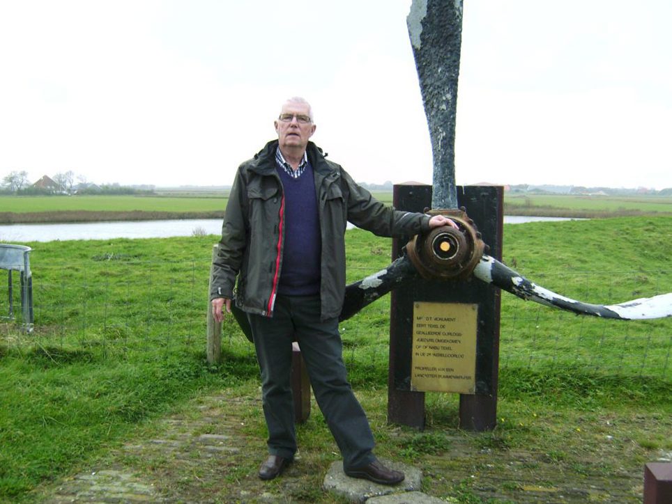 Bram van Dijk stands by a memorial to Canadian airmen on a dike in Texel, Holland. On Christmas Day on a tiny Dutch island, van Dijk will place a Yule decoration on the grave of a Canadian airman and wonder about Raymond Norman McCleery's family in Canada.