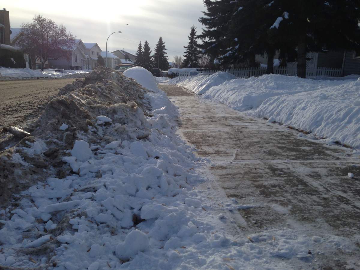 Snow accumulates on 41 Ave and 38 St in Edmonton, Dec. 16, 2013.