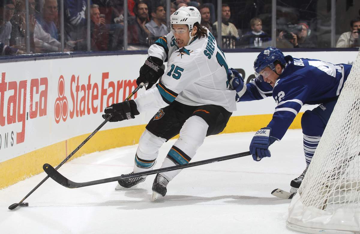  James Sheppard #15 of the San Jose Sharks skates with the puck against Tyler Bozak #42 of the Toronto Maple Leafs during an NHL game at the Air Canada Centre on December 3, 2013 in Toronto.