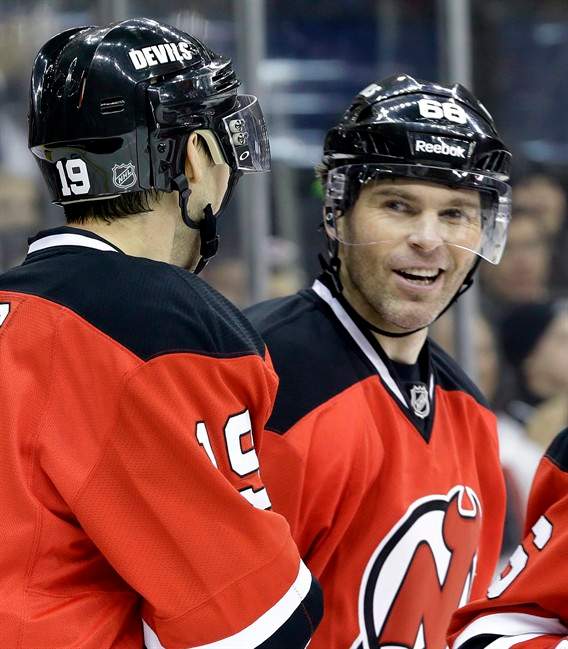 New Jersey Devils right wing Jaromir Jagr, right, of the Czech Republic, talks to center Travis Zajac.
