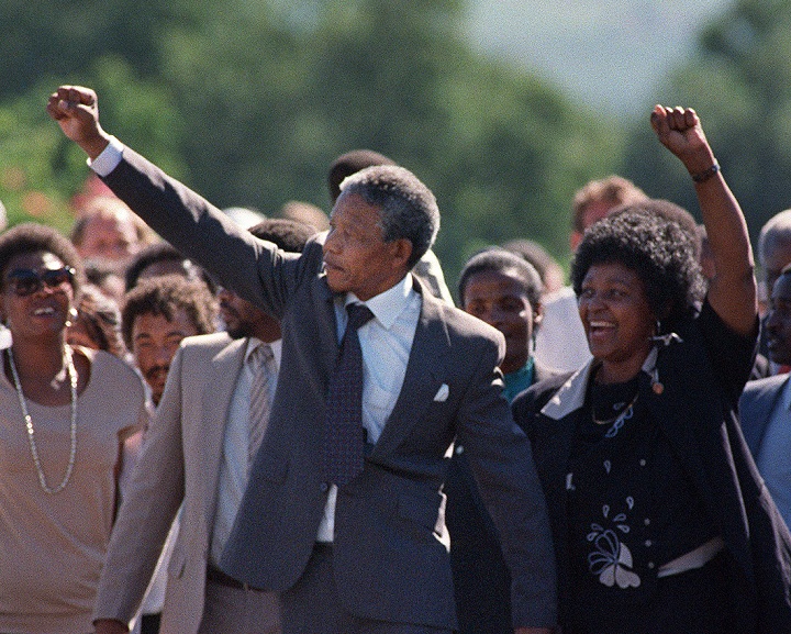 A picture taken on February 11, 1990 shows Nelson Mandela (C) and his then-wife Winnie raising their fists and saluting cheering crowd upon Mandela's release from the Victor Verster prison near Paarl.