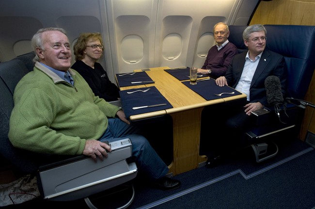 Former Canadian prime ministers Stephen Harper, Brian Mulroney , Kim Campbell and Jean Chretien on board a government plane headed for the memorial for South African icon Nelson Mandela in December 2013.