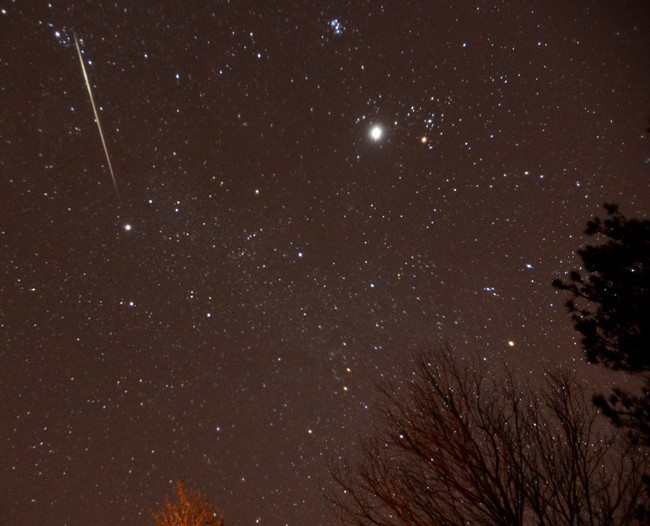  In this Thursday night Dec. 13, 2012 file photo, a meteor streaks across the sky during the annual Geminid meteor shower over Springville, Ala. 