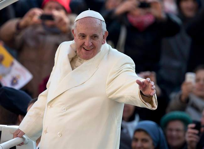 Pope Francis waves as he arrives for his weekly general audience in St. Peter's Square at the Vatican, Wednesday, Dec. 11, 2013.