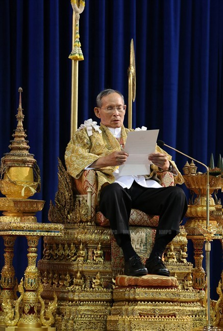 In this photo released by Thailand's Royal Household Bureau, Thailand's King Bhumibol Adulyadej reads a statement at Klai Kangwon Palace during a ceremony in celebration of his 86th birthday in Prachuap Khiri Khan province, Thailand, Thursday, Dec. 5, 2013. Thailand put politics aside Thursday to celebrate the birthday of the country's revered monarch, who used his annual birthday speech to call for stability but made no direct reference to the crisis that has deeply divided the nation. (AP Photo/Royal Household Bureau).