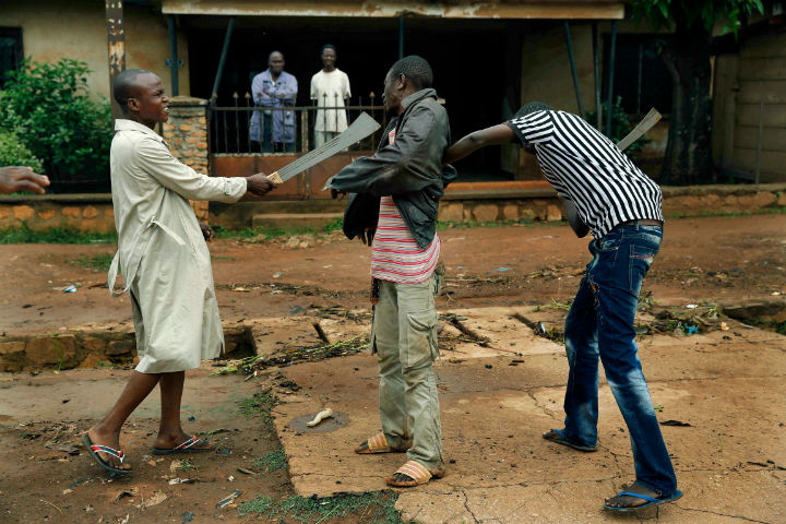 Muslim men armed with machetes rough up a Christian man in Central African Republic's capital Bangui