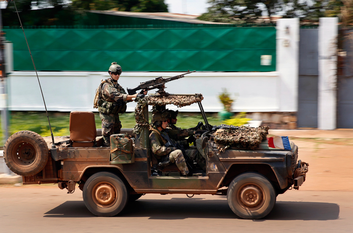 French Special Forces race through Bangui, Central African Republic, Thursday, Dec. 5, 2013 as gunfire and mortar rounds erupt in the town. To try to put an end to sectarian violence, the United Nations security council is scheduled to pass a motion allowing French troops to deploy in the country in order to protect civilians and insure security by all necessary means.