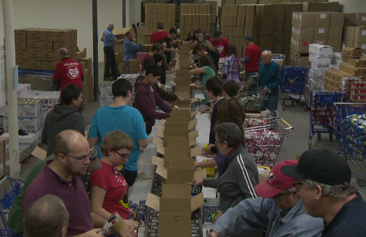 Students pack hampers at the Christmas Cheer Board warehouse on Ellice Avenue.