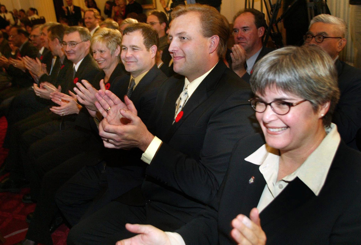 Christine Melnick (right) applauds after she was made a cabinet minister in 2003.