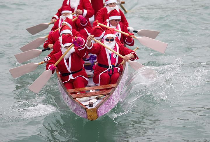 A close up of rowers dressed in Santa Claus costumes take part in the Christmas Regatta on the Grand Canal on December 21, 2013 in Venice, Italy. The Christmas Regatta now in it's 4th year is an event organised by University of Ca Foscari.